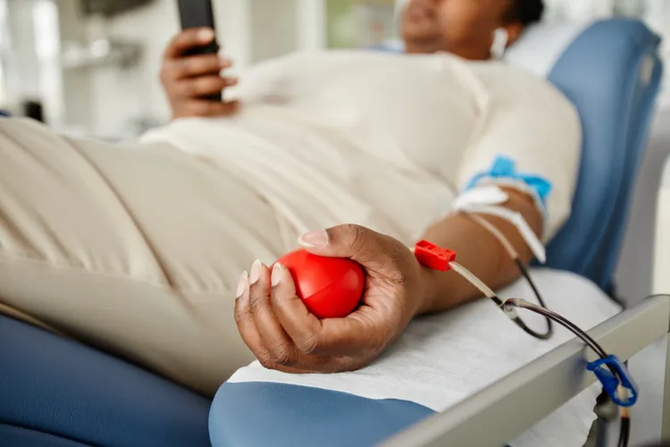 What Happens to Your Blood Pressure When You Donate Blood By Brandi Jones, MSN-ED RN-BC Published on July 30, 2026 Medically reviewed by Jordana Haber Hazan, MD Woman donating blood closeup while squeezing stress ball Blood donation may temporarily lower your blood pressure, but most people recover quickly. SeventyFour / Getty Images Table of Contents How Blood Donation Affects Your Blood Pressure Why You May Feel Dizzy How Long the Changes Last Can You Donate With High Blood Pressure? How to Prevent Dizziness Will Donating Blood Lower Your Blood Pressure Long-Term? Key Takeaways Blood donation temporarily lowers blood pressure because about 10% of your blood volume is removed. Most healthy adults recover quickly as fluid shifts back into the bloodstream. Current research does not show that donating blood lowers blood pressure over the long term. Donating blood causes a small temporary drop in blood pressure because you lose about 10% of your blood volume during the donation. While this may sound concerning, your body quickly adjusts, and blood pressure returns to normal within hours.1 How Blood Donation Affects Your Blood Pressure When you donate blood, you give about one pint (473 milliliters),2 which is roughly 10% of your total blood volume.3 This temporary drop in fluid means there is less pressure pushing against your blood vessel walls, causing your blood pressure to temporarily drop a few points.1 One small study found that right after donating, participants’ systolic blood pressure (top number) dropped by an average of 4 millimeters of mercury (mmHg). Their bottom number and heart rate did not change much.1 Another study confirmed that the potential risks of fainting due to low blood pressure after donation were present but small.4 Your body has built-in systems that help keep your core blood pressure steady, protecting your brain and heart. Its first move is a fluid shift, drawing water from your tissues into your bloodstream and stabilizing your circulation within minutes.1 Pressure sensors in your neck and chest, called baroreceptors, also sense the dip. They tell your heart to beat a little faster, keeping oxygen flowing smoothly to your brain.1 Why You Might Feel Dizzy or Lightheaded If you feel lightheaded during blood donation, it’s usually due to a temporary vasovagal reaction, which occurs when your nervous system overreacts.5 The needle, the sight of blood, or stress about donating, even if you don’t feel nervous, can trigger your “fight-or-flight” response and a burst of adrenaline. Your vagus nerve tries to calm your body, and sometimes it slams on the brakes too hard. Your heart slows, and your blood vessels widen, dropping your blood pressure too fast.6 For a short time, less blood reaches your brain, which can make you feel:5 Dizzy or lightheaded Nauseated (sick to your stomach) Warm or sweaty Weak Some people also faint, though this is uncommon.6 A vasovagal reaction does not mean you are weak or unhealthy. It is a normal body reflex that occurs more often in some people than others. Your risk is higher if you:6 Are dehydrated Are donating for the first time Are younger Feel anxious or uncomfortable around blood or needles Have a smaller body size or lower blood volume Have lower blood pressure before donating If you do feel dizzy, resting with your legs elevated, drinking fluids, and having a snack usually help you feel better. Why Dehydration Increases Your Risk of Dizziness When you are dehydrated, your body has a harder time pulling water from surrounding tissues to replace the lost blood volume. This can cause your blood pressure to drop further and make you feel lightheaded, especially if you stand up too quickly.7 How Long Do Blood Pressure Changes Last? Within minutes, fluid from nearby tissues moves into your blood to help refill lost plasma (the liquid part of your blood). In healthy adults, much of that plasma returns within the first hour,1 and the rest within about 24 hours. Your blood pressure usually returns to normal within a few hours.8 Replenishing your red blood cells takes longer because your bone marrow needs four to six weeks to fully replace them. This is why you have to wait eight weeks before donating again.8 Related Stories What Happens to Your Blood Pressure When You Cross Your Legs During a Reading Doctor measuring patient's blood pressure in clinic Don’t Ignore the Warning Signs: When Low Blood Pressure Becomes Life-Threatening Stressed anxious Asian woman holding head in hands, keeping eyes closed, suffering from headache or migraine. Stress and anxiety concept Can You Donate Blood With High or Low Blood Pressure? In most cases, yes, you can donate blood with high or low blood pressure as long as you feel well and your blood pressure is stable. And, taking blood pressure medication doesn’t automatically disqualify you.9 On donation day, a staff member checks your blood pressure to make sure it’s safe for you to donate. To qualify, your systolic (top number) must fall between 90-180 and your diastolic (bottom number) between 50-100 mmHg.10 Heart disease doesn’t rule you out either.11 You can usually donate if you’ve been treated for heart disease, have no restrictions on daily activities, and haven’t had any of the following in the last six months:12 A heart attack A heart medication change Angina (chest pain) Angioplasty (balloon procedure to open up blood vessels) Bypass surgery However, if you have a chronic disease or take medications, it’s a good idea to talk with your healthcare provider before donating.11 How to Protect Your Blood Pressure Before and After Donating You can help your body maintain steady blood pressure before and after donating with these steps.13 Before donating: Drink an extra 16 ounces of water Eat a salty snack, unless your provider has told you to limit sodium During donation: Tense your thigh and buttock muscles for about five seconds, release for five seconds, and repeat several times Listen to music or read to relax Tell the staff right away if you feel dizzy or lightheaded After donating: Rest in the refreshment area for 10-15 minutes8 and have a snack and a drink Keep drinking fluids over the next 24 hours Avoid alcohol, heavy lifting, hard exercise, and standing up too quickly7 for the rest of the day If you feel dizzy or lightheaded after you leave, sit or lie down until it passes.13 Will Donating Blood Lower Your Blood Pressure Long-Term? No, current research does not show that donating blood lowers your blood pressure long-term. Your blood pressure may drop slightly right after you donate, but it returns to baseline within about 24 hours as your body replaces lost fluid.8 High blood pressure (hypertension) develops when your blood vessels grow stiff or narrow. It does not come from having too much blood.1 You may come across articles or older studies suggesting that regular blood donors had lower blood pressure over time. However, more recent reviews have found the evidence is mixed. If studies seem to disagree, it may be because:14 Researchers may follow donors for different lengths of time Some people have higher blood pressure during their first donation because they feel nervous6 Studies compare different groups of people (e.g., regular blood donors may lead healthier lifestyles than the average person) Because of these differences, researchers cannot say that blood donation itself lowers blood pressure long-term.14
